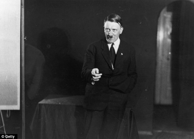 His eyes are drawn wide in this revealing the whites a sign of aggression. One hand is seen making a gesture of precision with the other awkwardly or perhaps casually stuffed into his pocket.